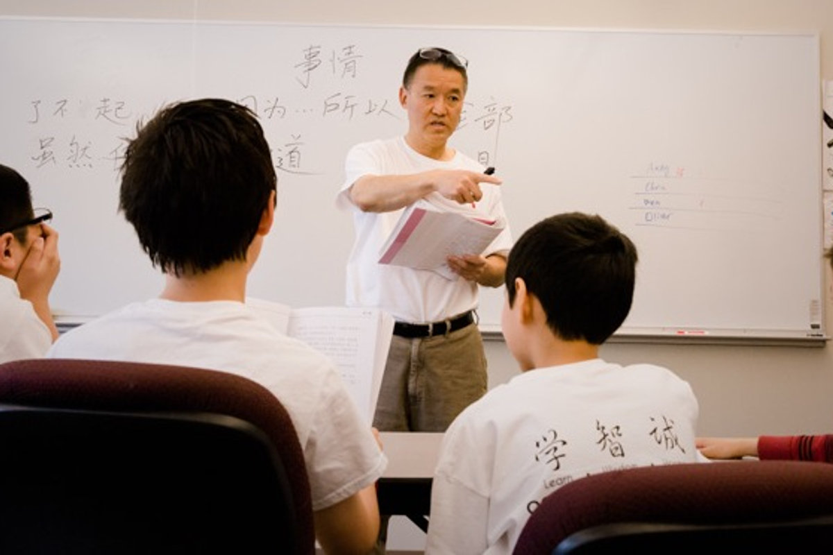 A teacher leading a Chinese language lesson, an image previously shown on the school website
